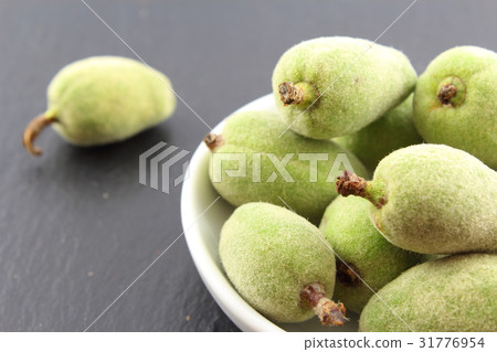 fresh green almond fruits in a small white bowl fresh green almond fruits in a small white bowl 31776954