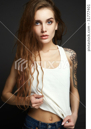 Young blond woman with tattoo 31777401