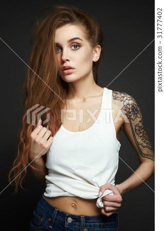 Young blond woman with tattoo Young blond woman with tattoo 31777402