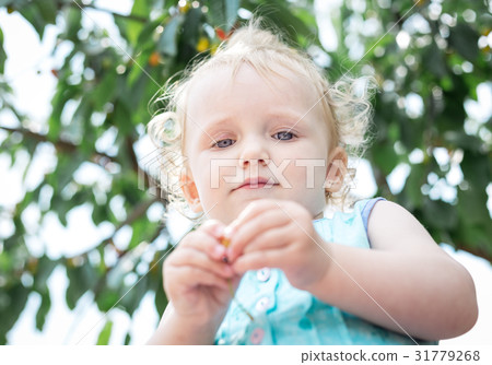 Girl on the background of a cherry tree. Girl on the background of a cherry tree. 31779268