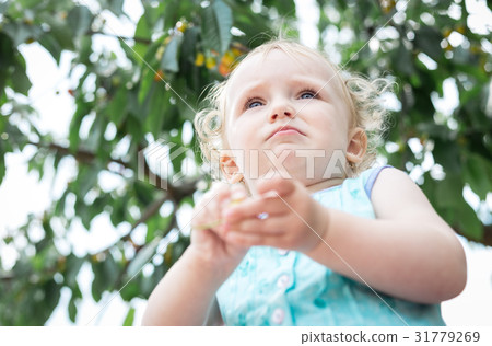 Girl on the background of a cherry tree. Girl on the background of a cherry tree. 31779269