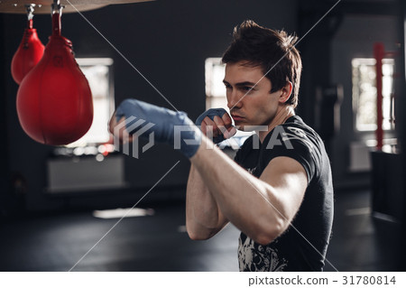 Young man boxing workout in a fitness club Young man boxing workout in a fitness club 31780814