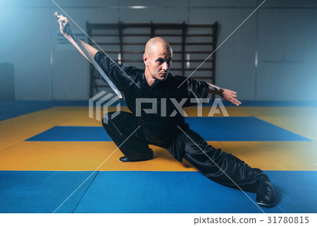 Wushu master training with sword, martial arts Wushu master training with sword, martial arts 31780815