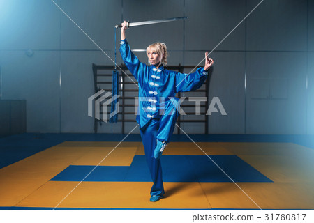 Female wushu fighter with sword in action 31780817