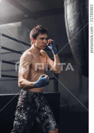 Muscular fighter prepare for practicing some kicks 31780863