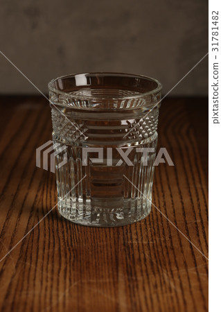 Glass of water on a wooden table. Close up 31781482
