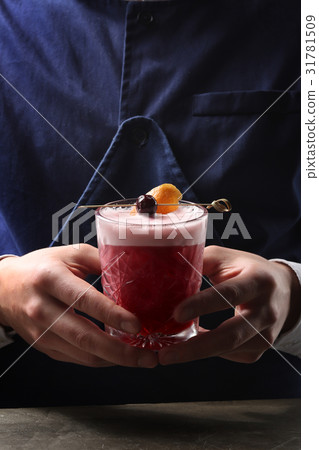 Tasty cherry cocktail in bartenders hands. Close Tasty cherry cocktail in bartenders hands. Close 31781509
