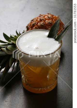 Pineapple and a glass of beer 31781553