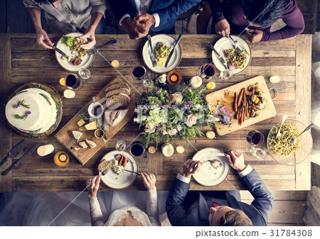 Bride and Groom Having Meal with Friends at Wedding Reception 31784308