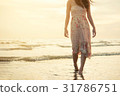 Happy asia woman Enjoying Beautiful Sunset  Beach 31786751