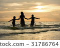 happy family run on beach during sunset time 31786764