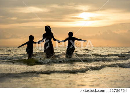 happy family run on beach during sunset time happy family run on beach during sunset time 31786764