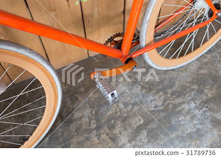 bicycle parked with wood wall, close up image 31789736