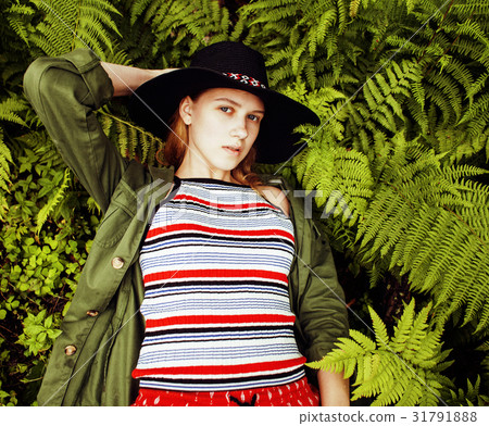 Pretty young blond girl hipster in hat among fern Pretty young blond girl hipster in hat among fern 31791888