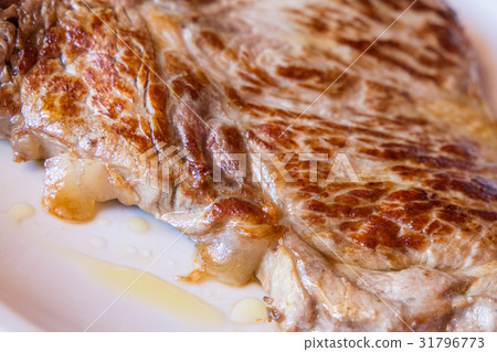 Closeup of a grilled steak on white plate Closeup of a grilled steak on white plate 31796773