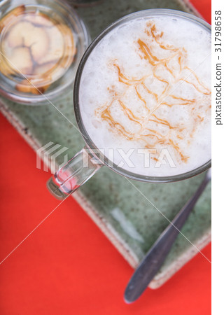 Cup of coffee and biscuit on green clay background 31798658