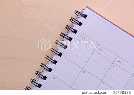 Planner notebook on wooden background 31798886