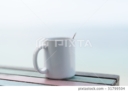 White coffee cup on vintage table blurred White coffee cup on vintage table blurred 31799504