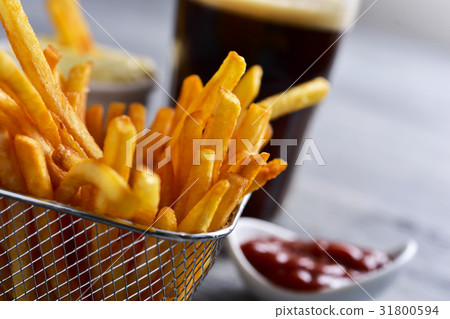 french fries in a metal basket and a soda french fries in a metal basket and a soda 31800594