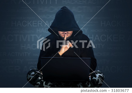 Computer hacker stealing data from a laptop 31803677