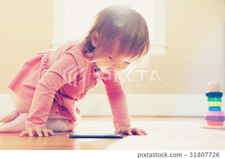 Happy toddler girl playing with her tablet computer 31807726
