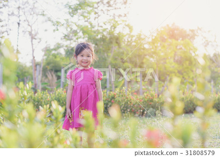 Cute child playing in the garden in the summer 31808579