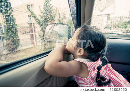 Child little girl looking the rain falling 31808960