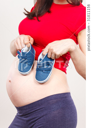Pregnant woman with baby shoes, expecting for baby 31811156
