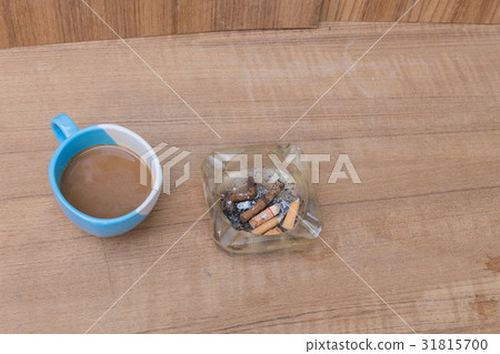 Coffee and burning cigarette in ashtray 31815700