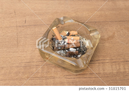cigarette with an ashtray on the wood table 31815701
