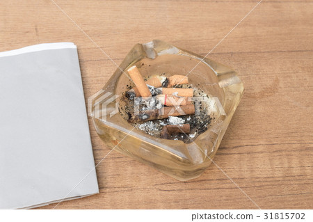 cigarette with an ashtray on the wood table 31815702