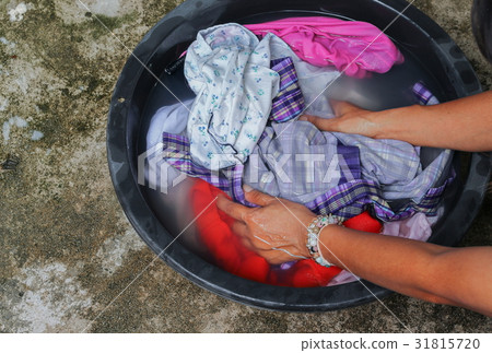 Woman wash launder hands in basin black 31815720
