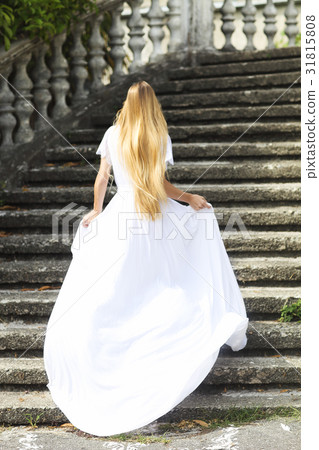 Beautiful running bride outdoors in park 31815808