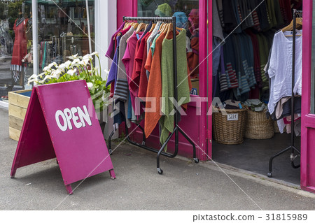 Brightly colored Open sign outside a shop Brightly colored Open sign outside a shop 31815989