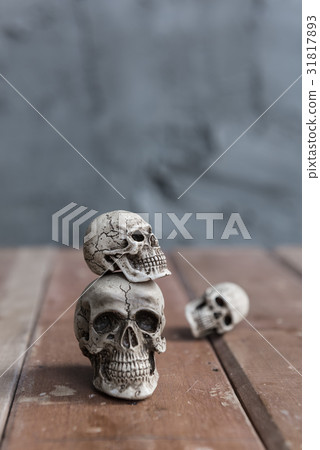Triple skull on wood floor with grunge background Triple skull on wood floor with grunge background 31817893
