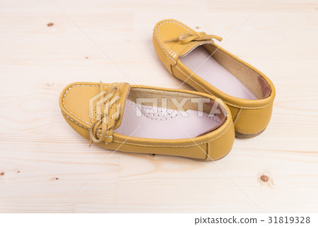 Yellow casual leather flat shoe on wood background 31819328