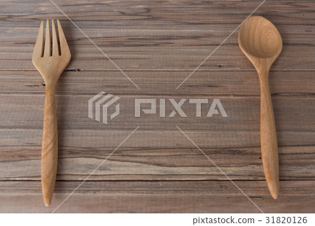 Fork and spoon on wooden table 31820126