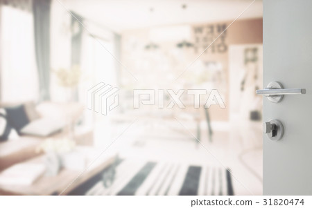 opened white door to modern living corner 31820474