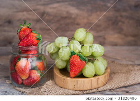 Grapes and strawberry fruit set on wood tray Grapes and strawberry fruit set on wood tray 31820490