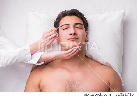 Handsome man in spa massage concept 31821719