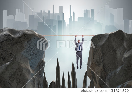 Businessman hanging on rope in danger concept 31821870