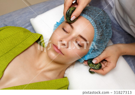 Spa treatment. Massage with jade stones 31827313