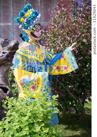 beautiful chinese girl in traditional chinese dress with long sleeves and hat standing outdoor beautiful chinese girl in traditional chinese dress with long sleeves and hat standing outdoor 31829043