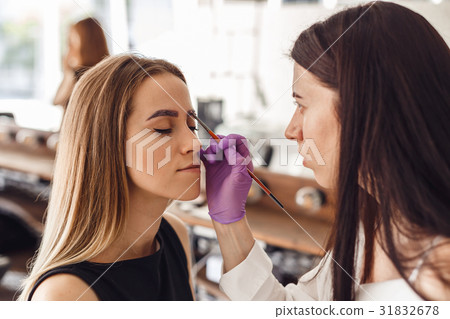 Portrait of professional cosmetologist in purple 31832678