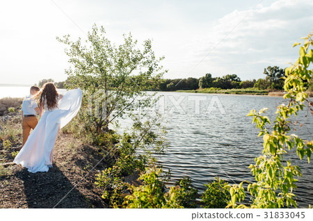 Happy bride and groom on a wedding walk Happy bride and groom on a wedding walk 31833045