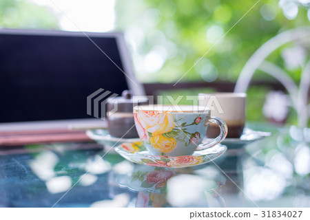 Cup of hot drink with coffee on table. 31834027
