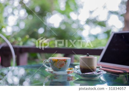 Cup of hot drink with coffee on table. 31834057