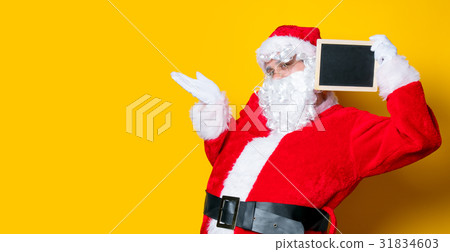 Funny Santa Claus holding black board Funny Santa Claus holding black board 31834603