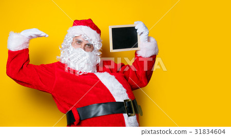 Funny Santa Claus holding black board Funny Santa Claus holding black board 31834604