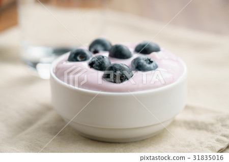 organic blueberry yogurt in bowl on table organic blueberry yogurt in bowl on table 31835016
